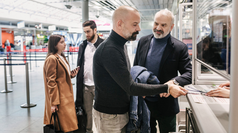 two men with beards at the flight counter