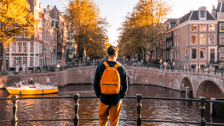 Person wearing backpack and overlooking canals in Amsterdam