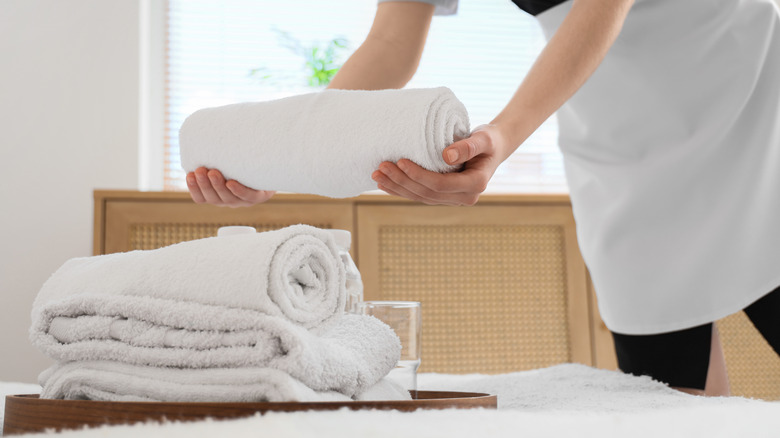 hotel housekeeping service holding towels