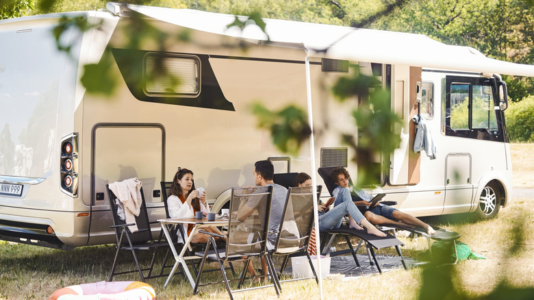 Family relaxing at RV campground