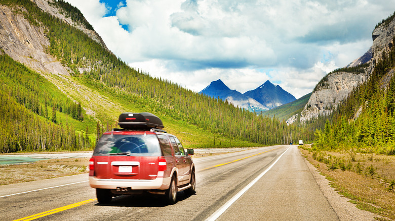 Car on a highway through the Rocky Mountains