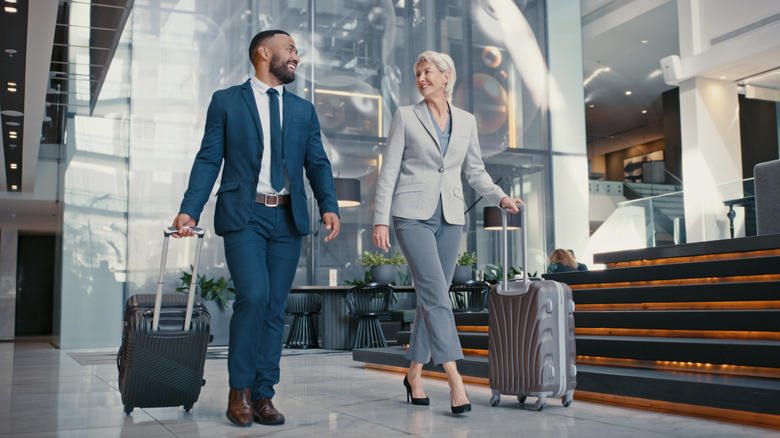 Two smiling business travelers