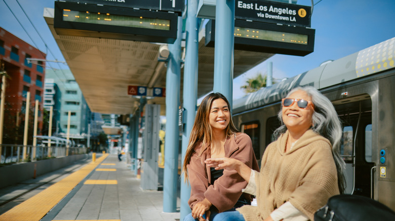 Two women on a train platform in Los Angeles.
