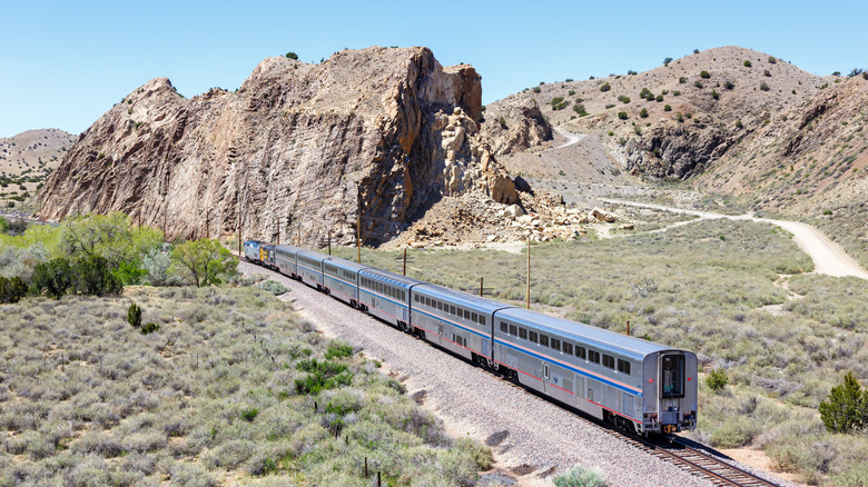 A train travels through mountains in the Southwest.