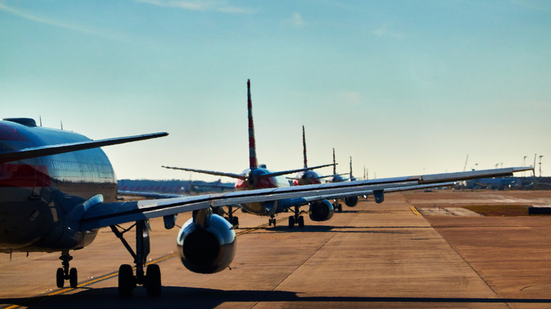 Dallas Airport, aircraft wings, long line of planes waiting for taxi.