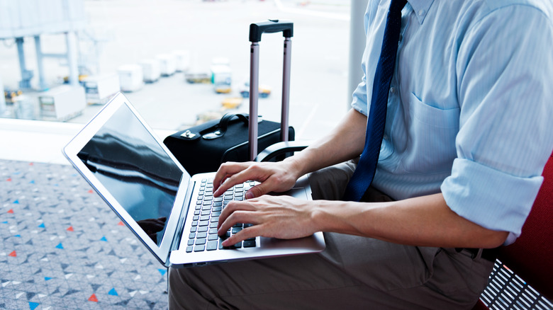 Man using laptop at airport