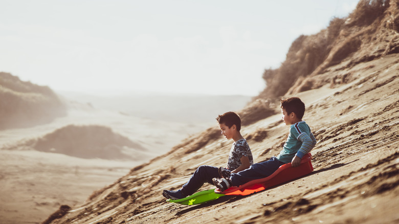 Kids sand sledding