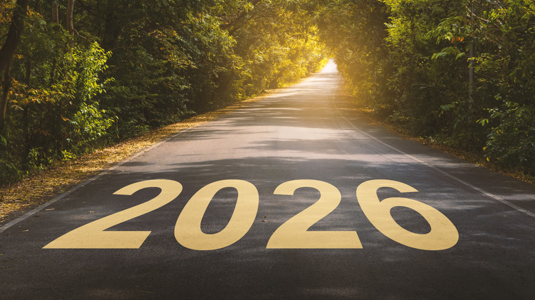 2026 written on a road passing through trees