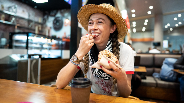 Woman eating at the airport