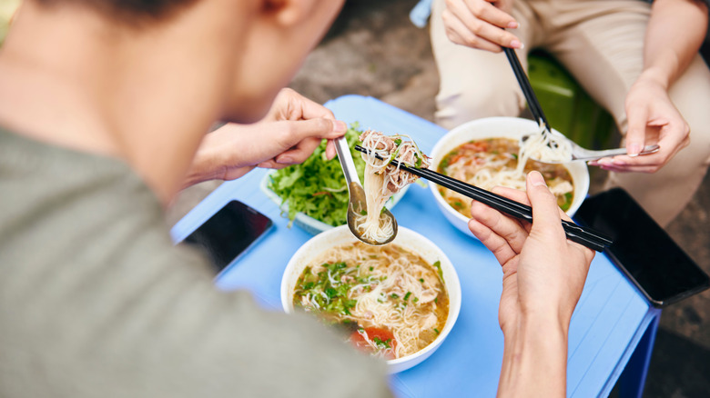 people eating pho