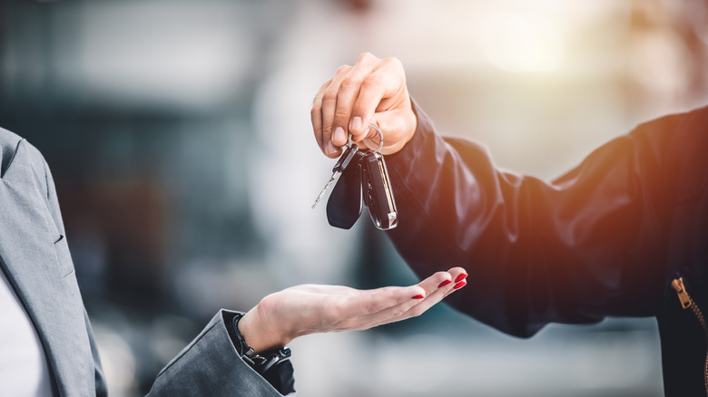 handing over the keys to a car