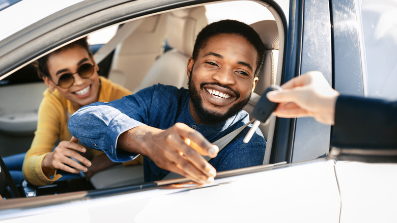 happy couple renting car