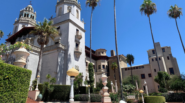 Hearst Castle from below surrounded by palm trees