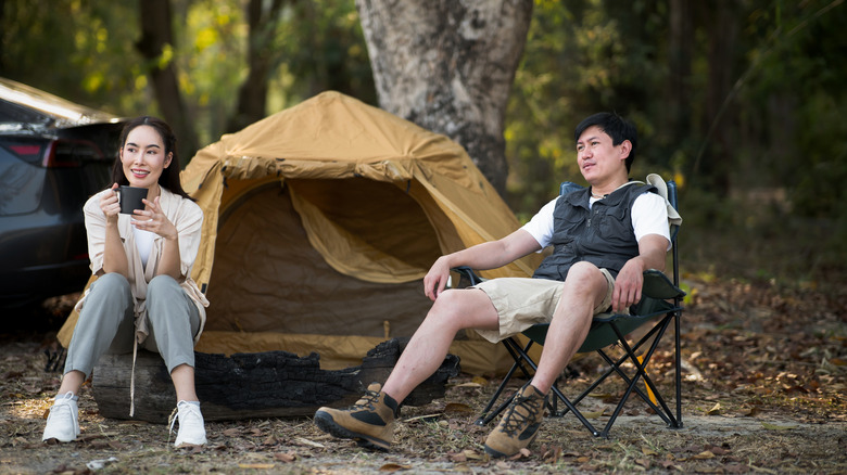 couple enjoying coffee at camp