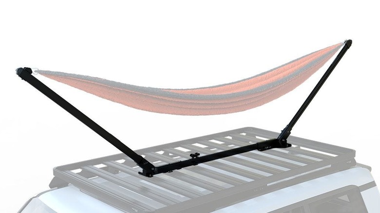 A dometic hammock stand setup on a front runner rack on top of a car