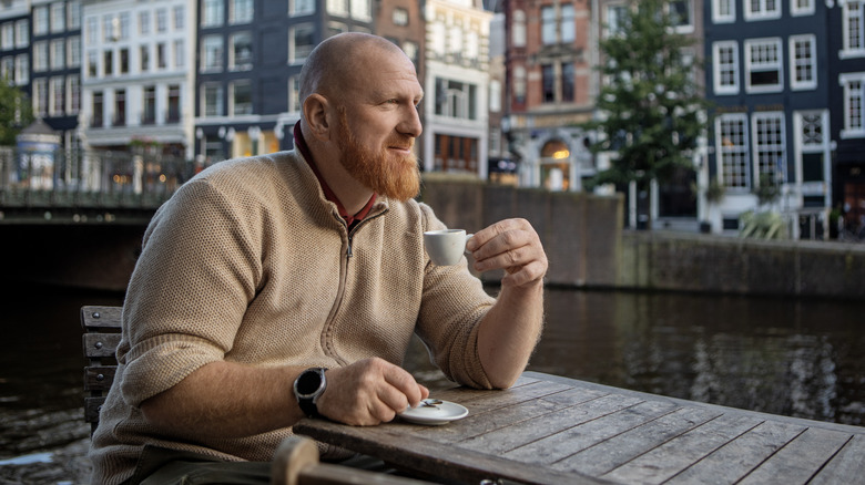 large bald man drinking an espresso in Amsterdam