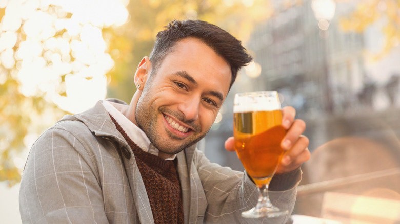 man lifting his bear glass in Amsterdam