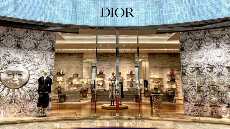 glitzy Dior storefront with glass doors, mannequins