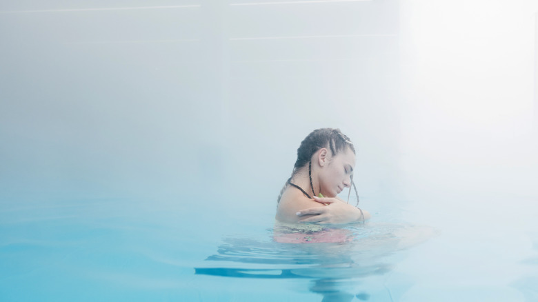 Woman enjoys hot springs pool.