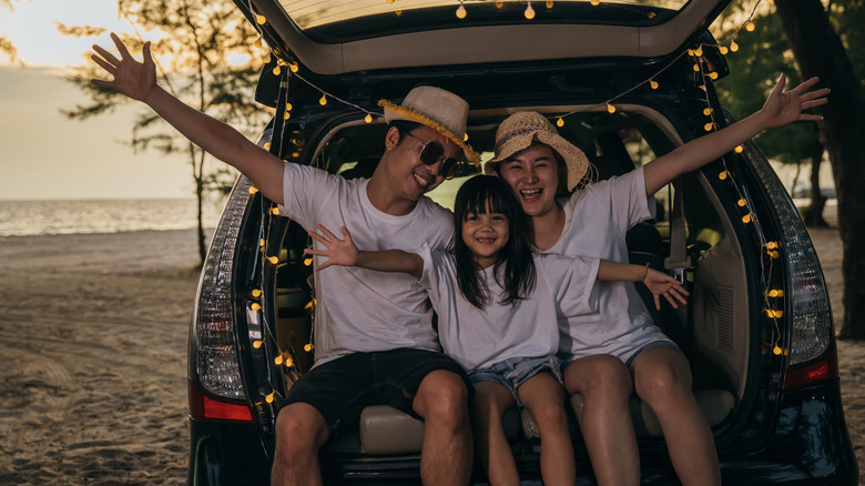 happy family in car at beach