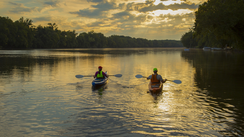 two kayakers at sunset