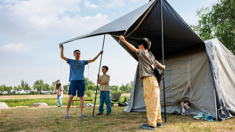 family setting up tent