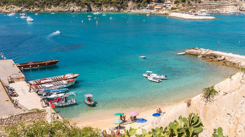 A small beach in a cove with fishing boats