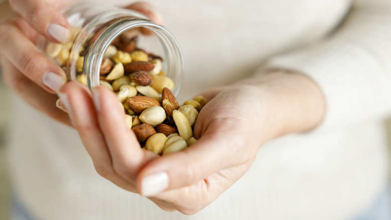 A woman dumping nuts in her hand