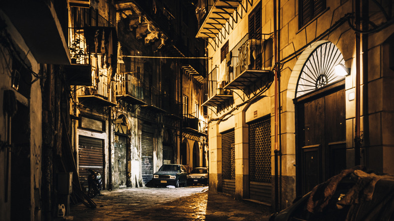 narrow street lit by streetlights