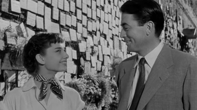 A black and white still of Gregory Peck and Audrey Hepburn in Roman Holiday