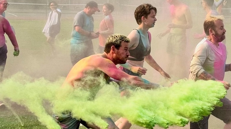 Group of people competing in a color war at 'Camp' Camp