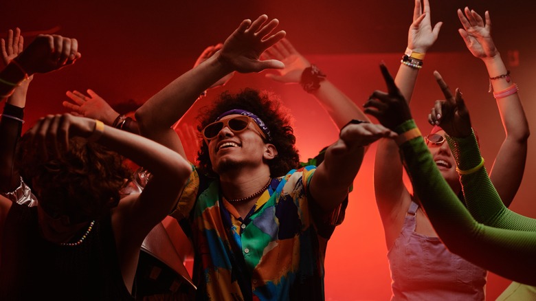 Young people dancing in funky clothes