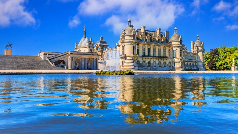 A grand palace reflecting on the fountain