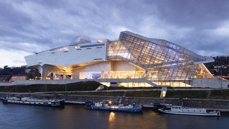 A futuristic glass building on the river in Lyon