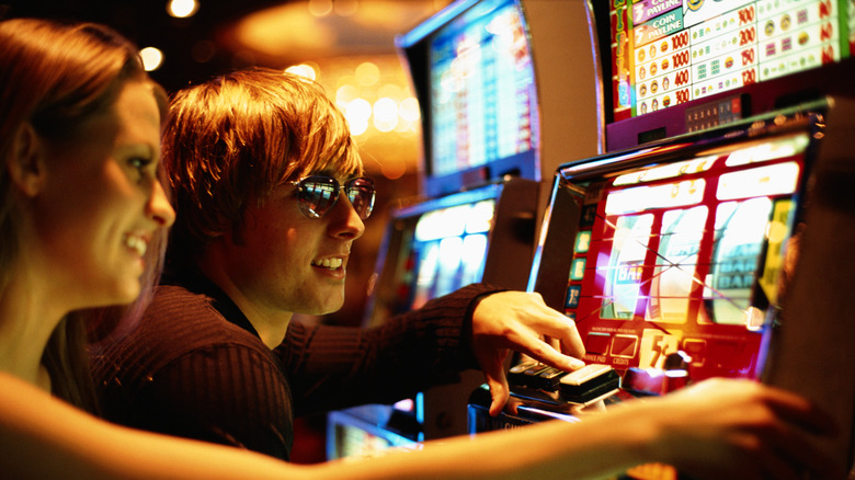 couple playing slot machines