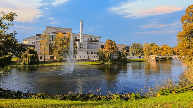 Autumn in Riga, view of the City Channel in the autumn colors and National Opera building reflected in the water