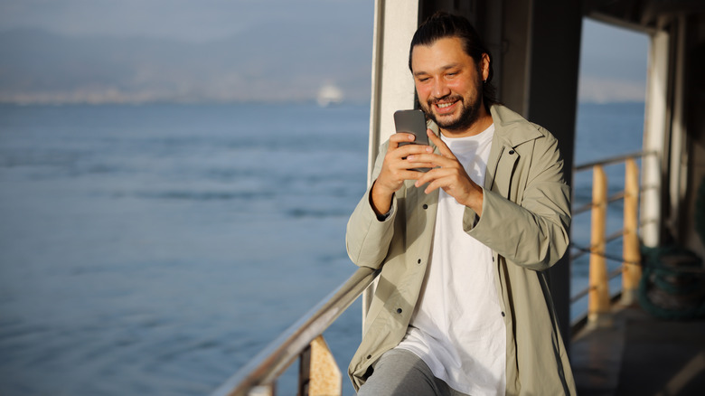 Man on a cruise ship with phone