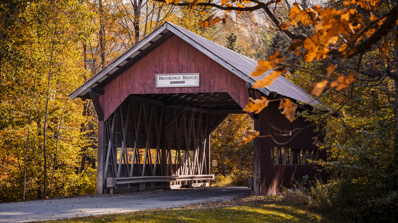 Covered bridge in Vermont surrounded by fall foliage