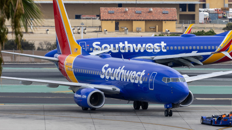 Southwest Airlines Boeing 737-700 taxiing at San Diego International Airport with another Southwest 737 in the background.