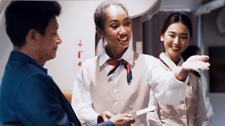 Flight attendants greeting passengers
