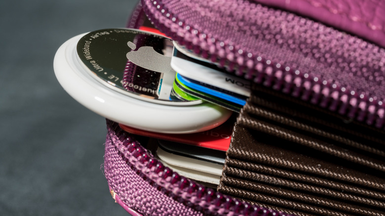 an AirTag sticking out of card wallet