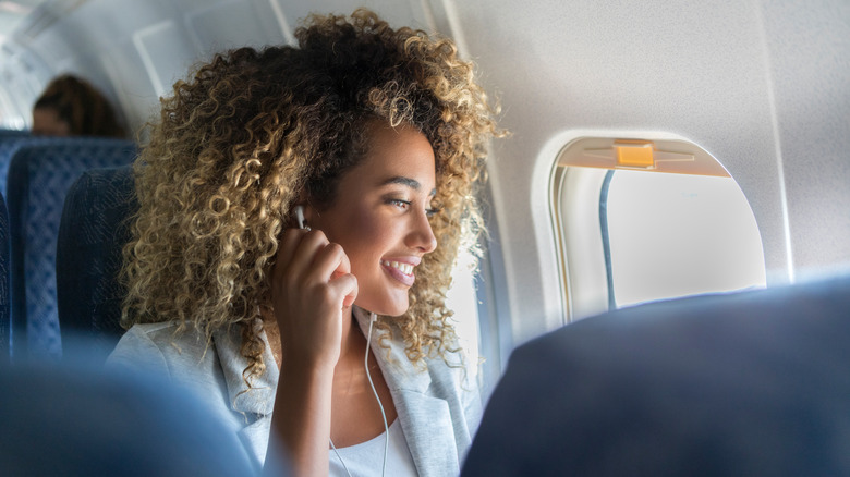 Smiling woman on airplane