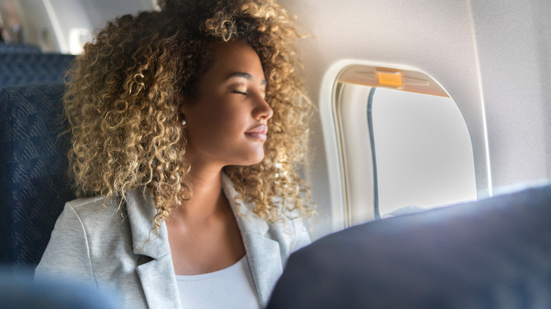 Woman asleep on a plane