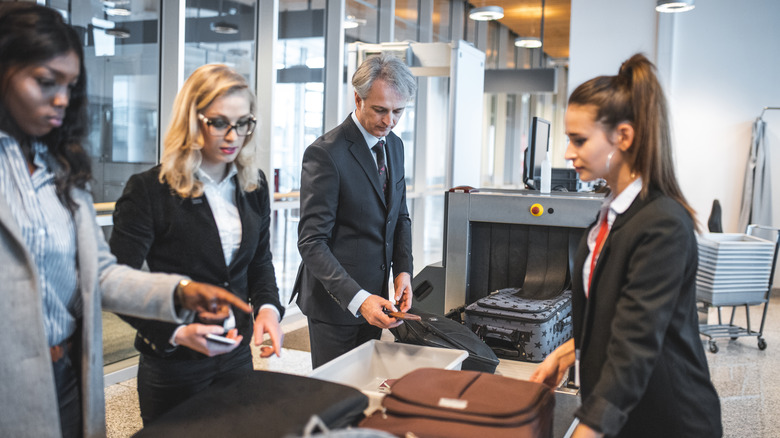Airport Security Checking Passengers Luggage