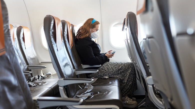 Woman alone in airplane row
