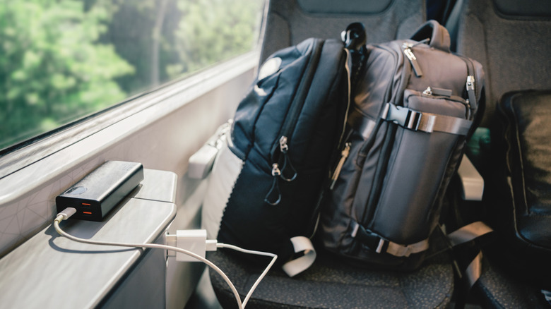 Luggage is stacked on a seat on an Amtrak train