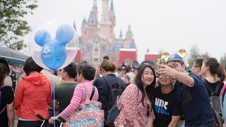 A trio poses for a selfie in Disney World