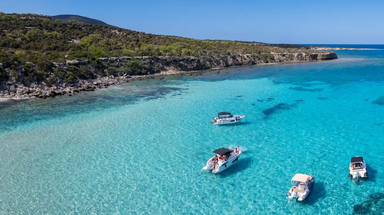 Four boats on the clean, clear waters off the coast of Cyprus