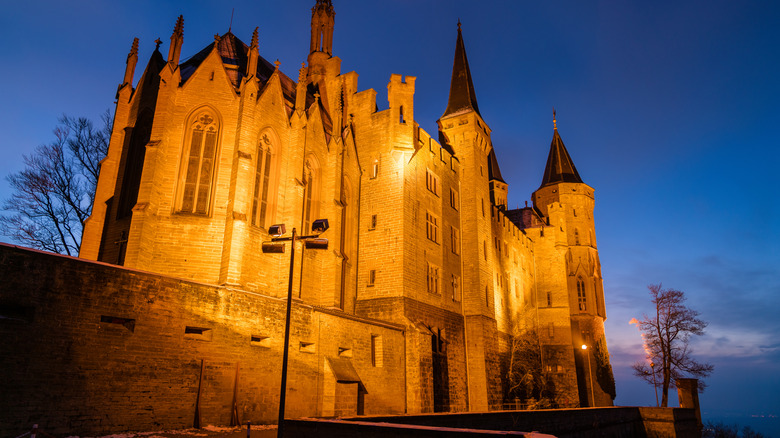 From below, the walls of Hohenzollern Castle are seen lit up at night