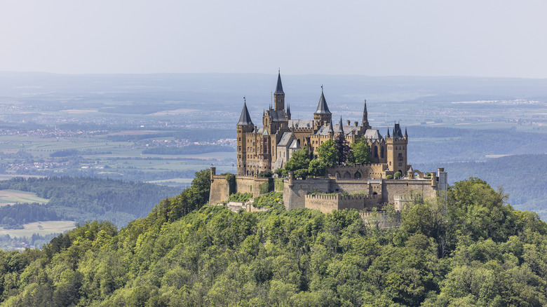 Hohenzollern Castles stands atop a mountain in Germany